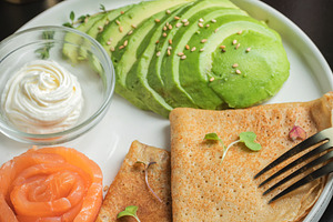 Roasted thin pancakes with smoked salmon and sauce, a Food & Drink Photo by Budarinphoto
