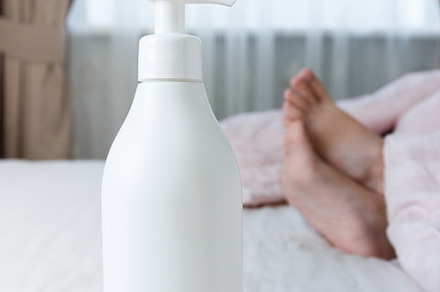 White bottle with a cosmetic product, a Person Photo by Lisssbetha