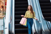 Happy Woman Shopping Walking Holding Colorful Shopper Bags In Hypermarket, a Photo by Prostock-Studio (Thumbnail 3 of 3)