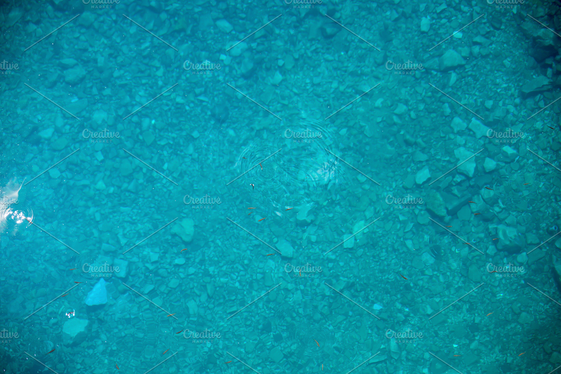 Blue water surface in a lake with a stone bottom, an Abstract Photo by Davizro's Market
