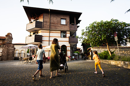 Mother with kids walking in the old town of Nessebar., a Person Photo by AS photostudio