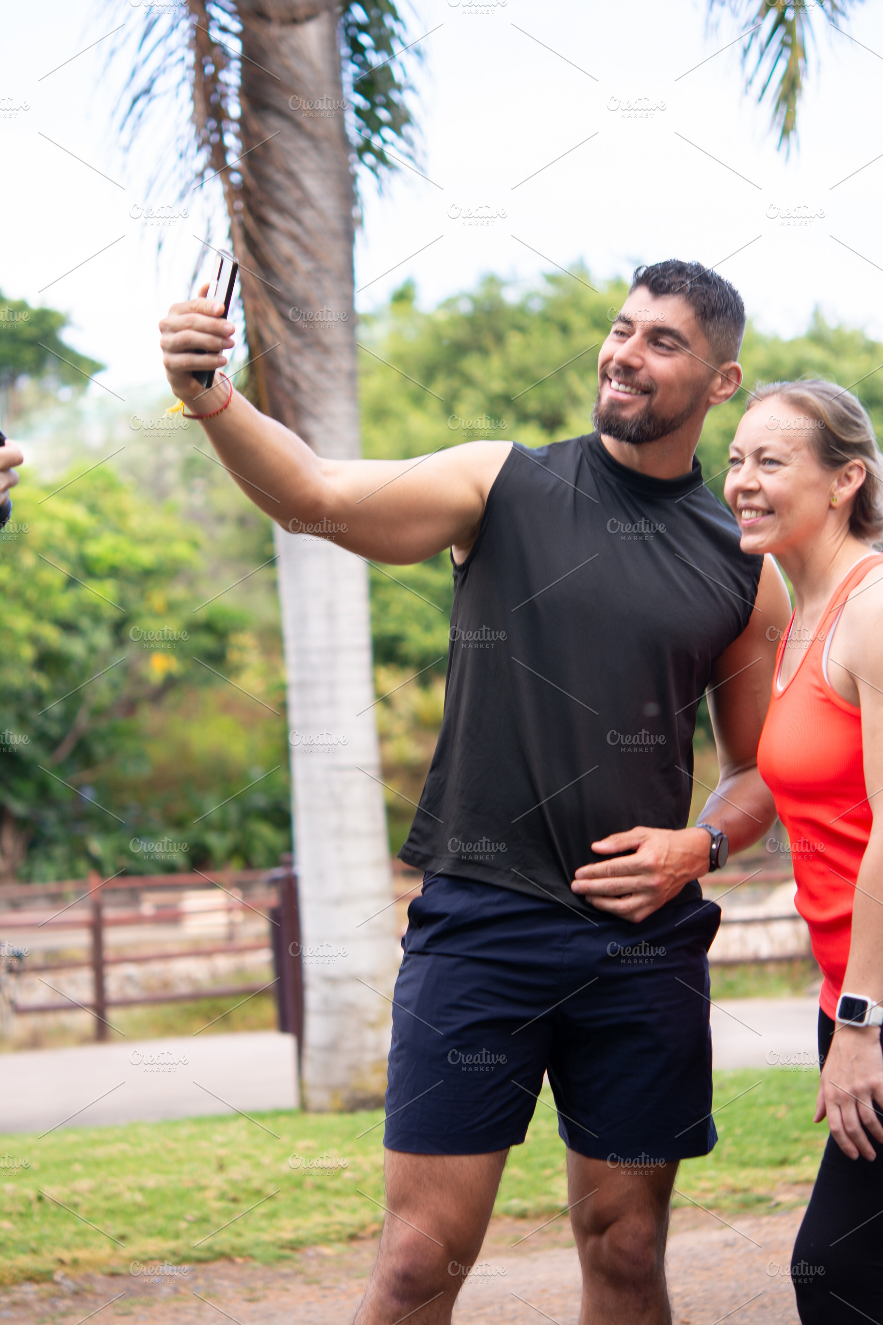 Fitness couple taking selfie together during outdoor workout in park, a Person Photo by etorres69