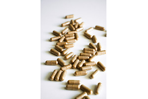 Brown herbal capsules scattered on, a Health & Medical Photo by volodymyrshtun13795