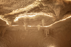 Illuminated rock formations with salt stalactites and atmospheric lighting in u, a Photo by AS photostudio