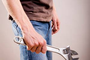 Man Holding Adjustable Wrench, an Industrial Photo by THP Creative