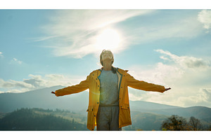 Joyful girl standing with open arms