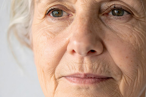 Elderly woman portrait with gentle face and subtle wrinkles, a Person Photo by GoodGoods
