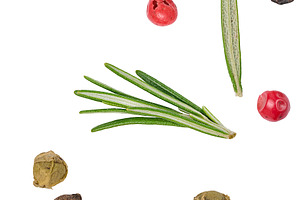 Colorful peppercorns and fresh rosemary needles scattered freely, a Food & Drink Photo by ndanko
