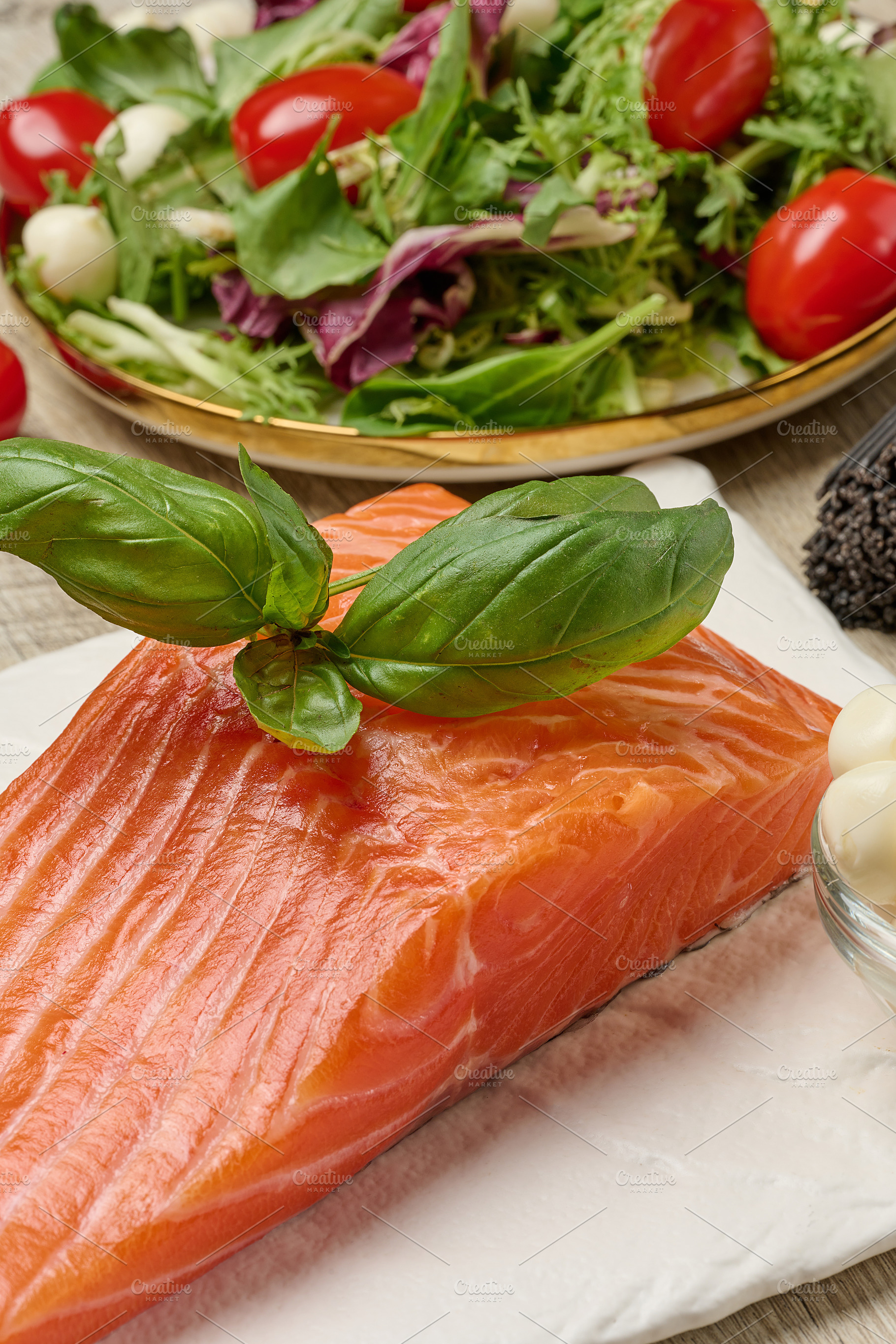 Raw salmon steak with mozzarella balls, pepper and green salad, a Food & Drink Photo by ndanko