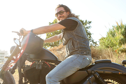 Young man wearing sunglasses on a chopper motorcycle, a Person Photo by 2Design