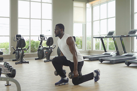 Portrait of strong black african american man using fitness equi, a Photo by Tampatra