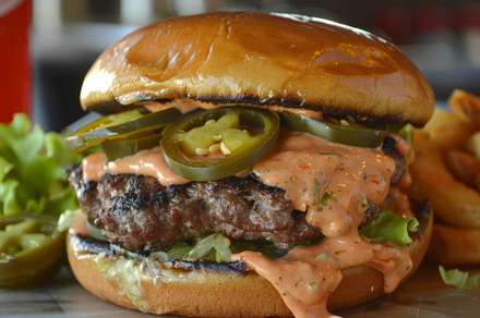 A spicy cheeseburger topped with pep, a Photo by Iftikhar Alam