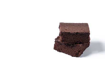 Chocolate brownie portions isolated on white background, a Food & Drink Photo by etorres69
