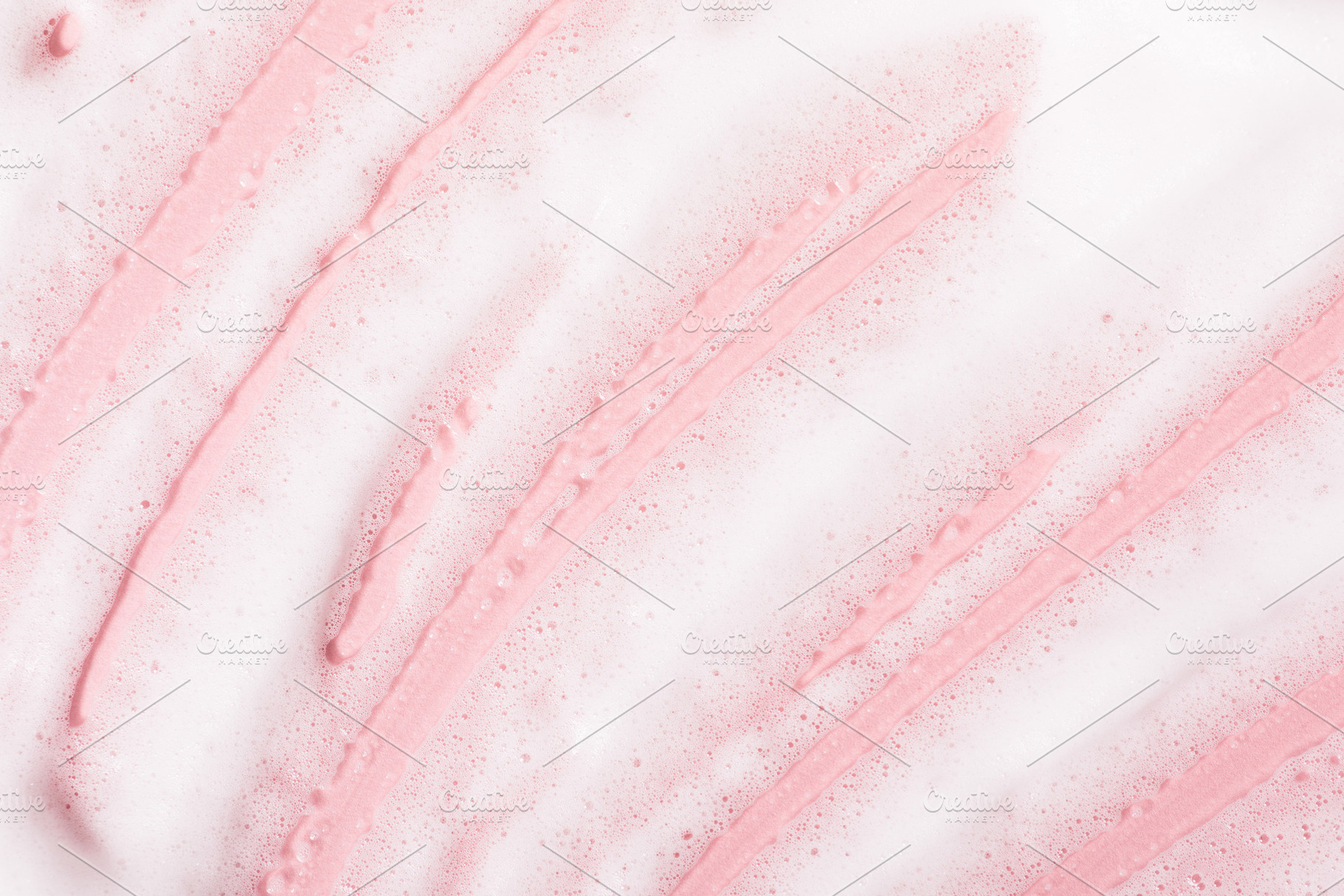 White bubble foam smudged on pink surface, a Beauty & Fashion Photo by progressman