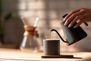 Pouring water into a coffee cup