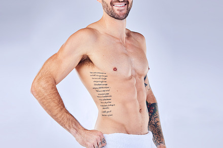 Man, fitness and towel portrait for strong bodybuilder athlete posing on a grey studio background. Athletic, shirtless and abs with a personal trainer and six pack for bodycare, skincare and hygiene, a Photo by Peopleimages.com