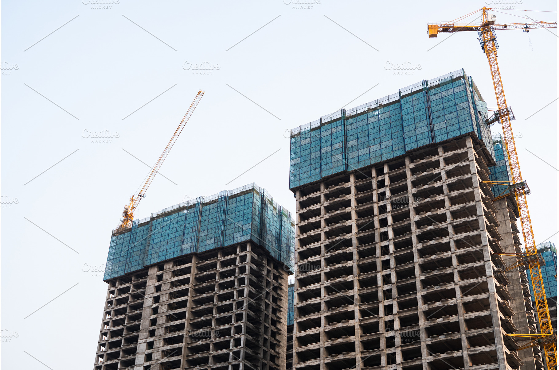 Tall unfinished skyscrapers with, an Industrial Photo by volodymyrshtun13795