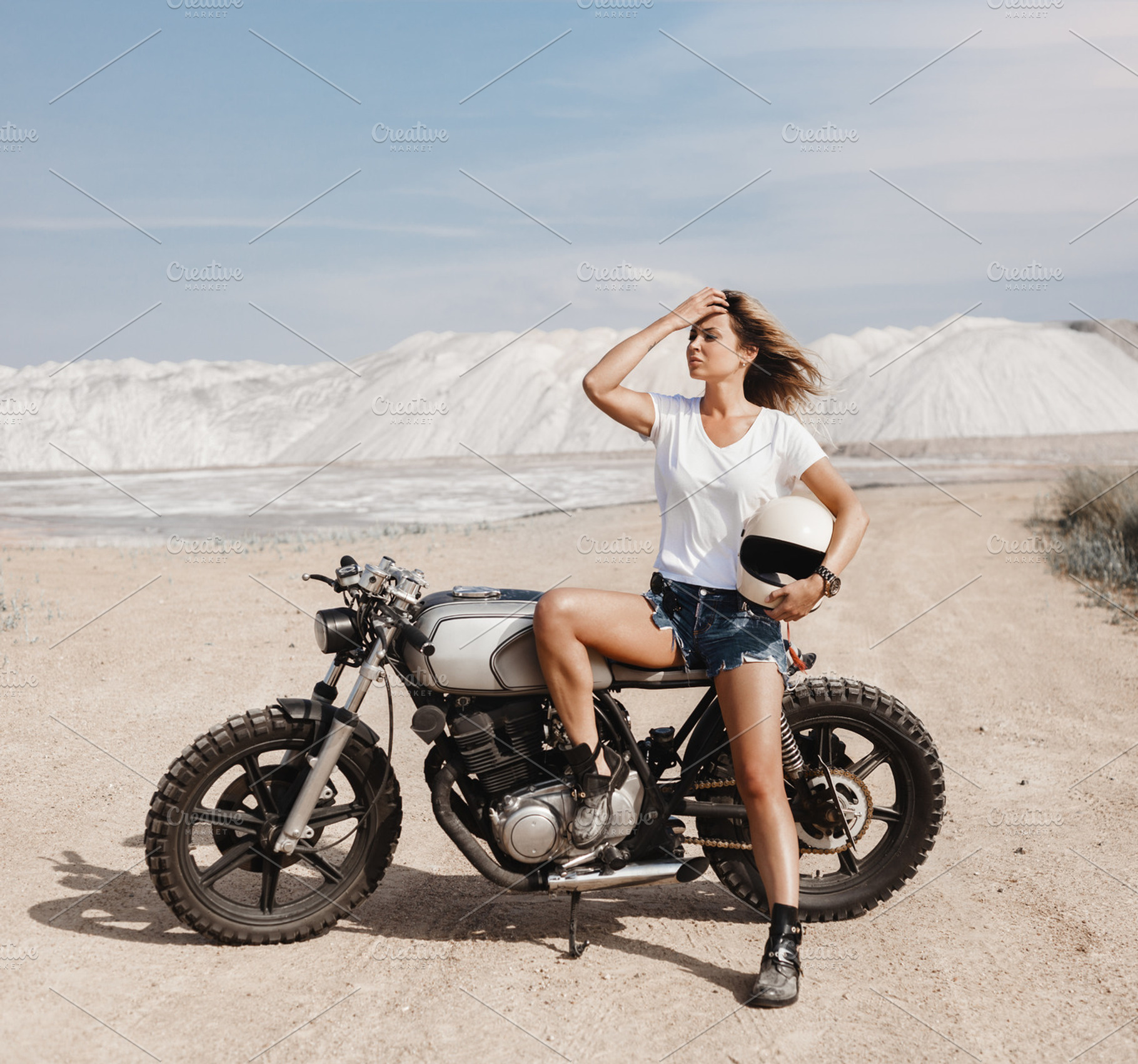 Female on custom built cafe racer motorcycle stock photo containing, a Transportation Photo by Aliaksei Kaponia