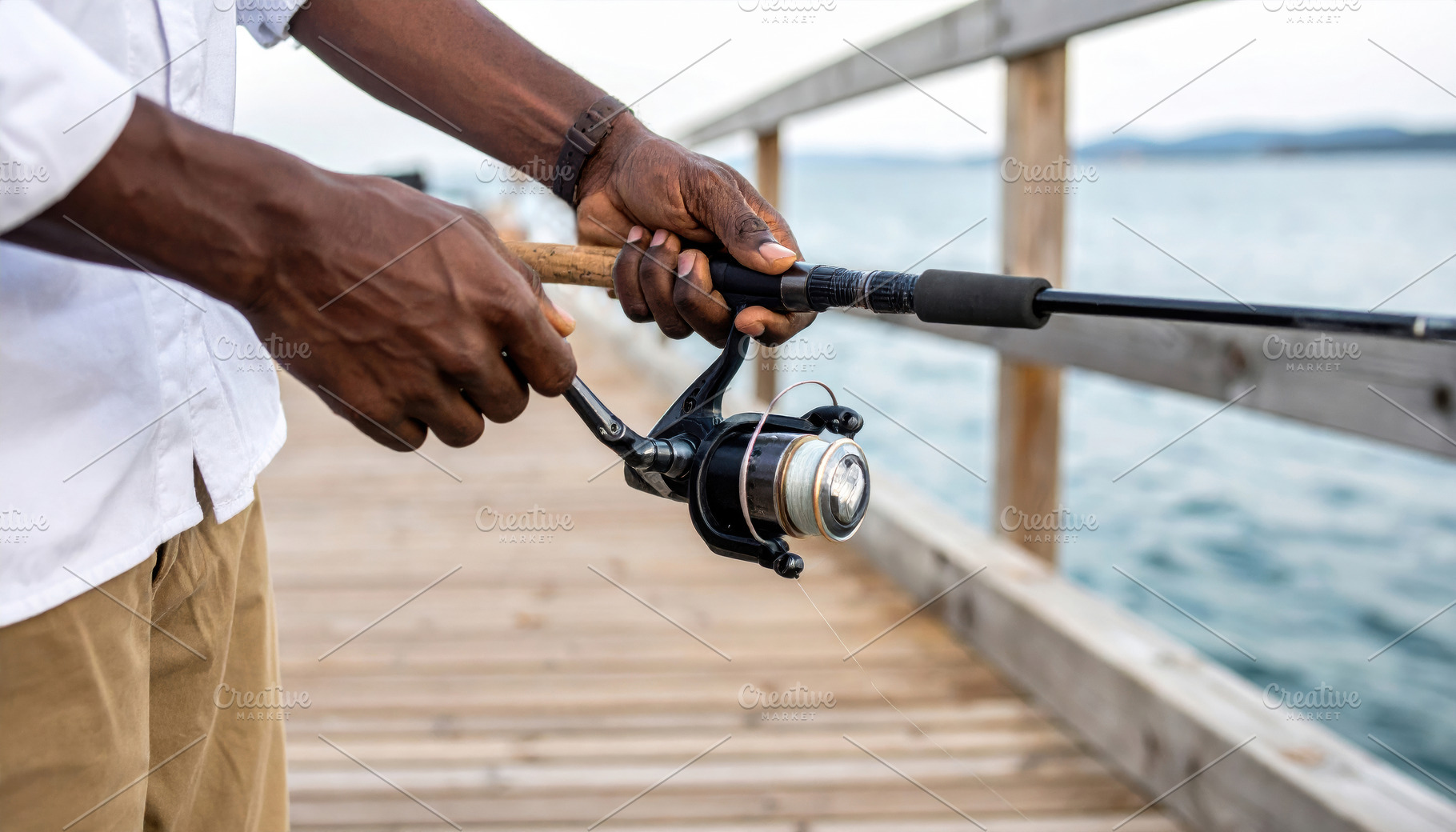 Man Preparing a Fishing Rod on a Pier, a Sports & Recreation Photo by Davizro's Market