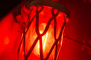Red alarm light inside an old military submarine with protective, an Architecture Photo by GoodGoods