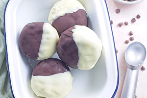 Dark and white chocolate covered ice cream sandwiches, on white plate, vertical, a Food & Drink Photo by iuliia_n