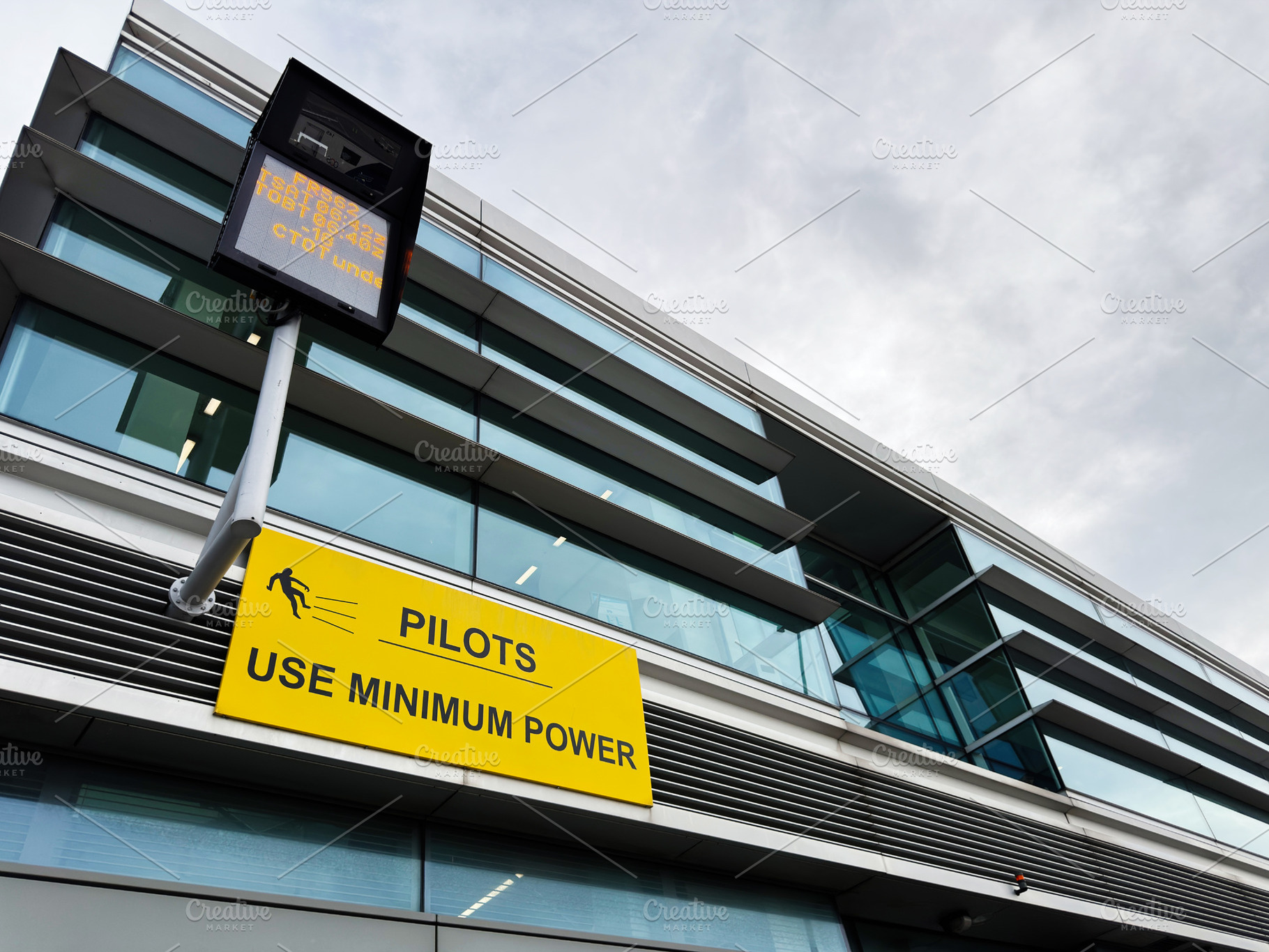 Pilots sign on modern airport building facade in Dublin, Ireland advising use m, a Photo by AS photostudio