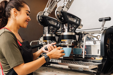 Female barista making coffee containing female, barista, and coffee machine, a Business Photo by Artem Varnitsin