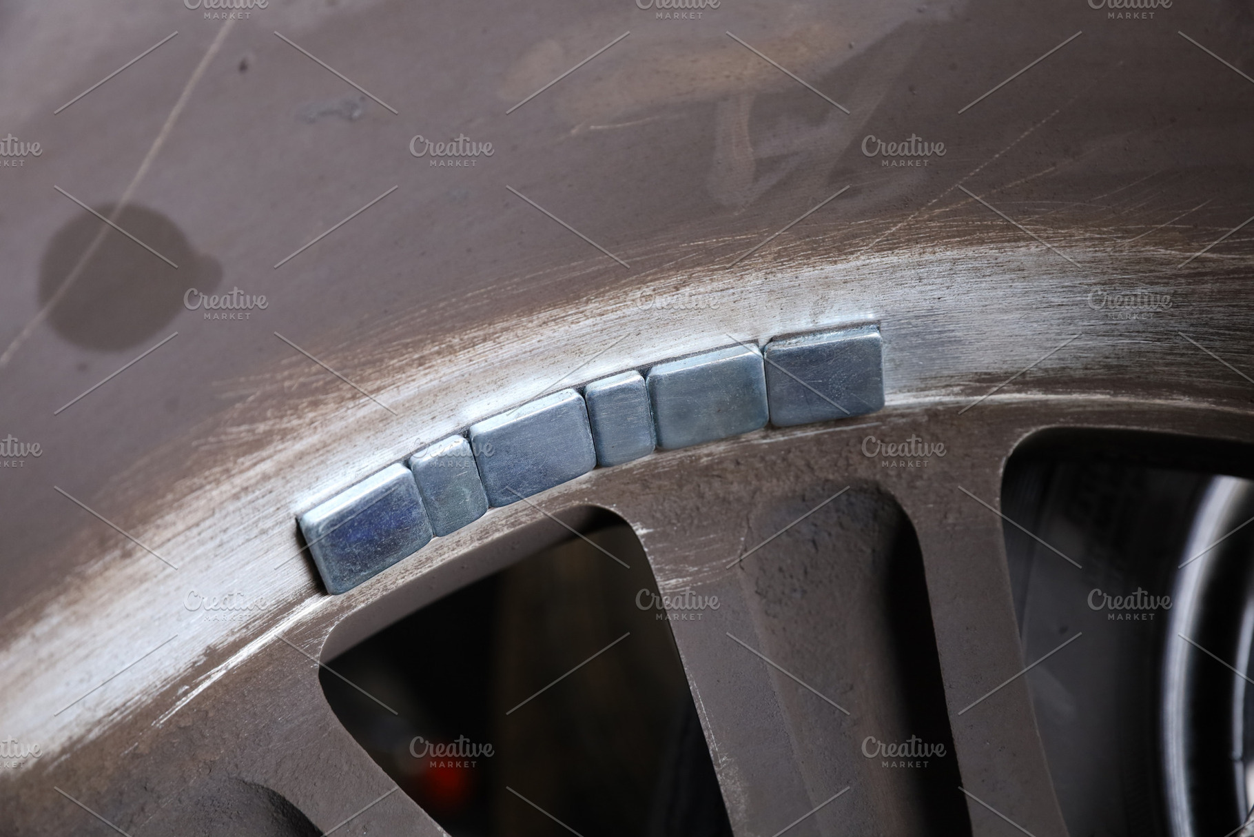 Balancing lead mounted on car wheel, a Transportation Photo by Smith Chetanachan