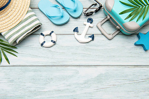 Summer vacation accessories lying on wooden background with copy, a Holiday Photo by Olena Rudo