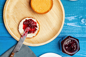 Preparing tasty breakfast with bread, butter, jam and cappuccino on blue wooden, a Food & Drink Photo by Antonio Gravante Market
