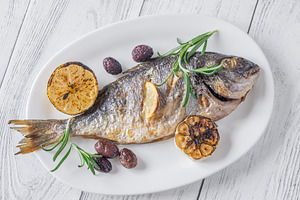Whole roasted sea bream with lemon rosemary olives and carameliz, a Food & Drink Photo by Alexander Prokopenko