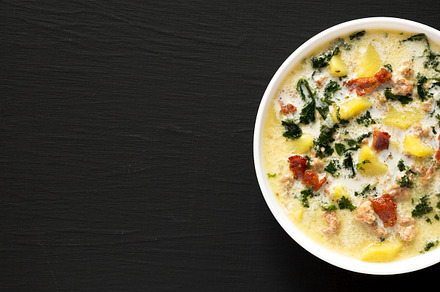Homemade Zuppa Toscana with Kale and Bread in a white bowl on a, a Food & Drink Photo by LiudmylaChuhunova
