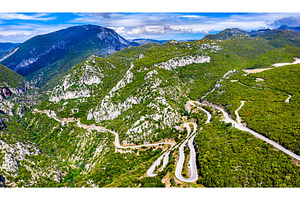 Winding road in the mountains of containing mountain, road, and landscape, a Transportation Photo by Leonid Andronov