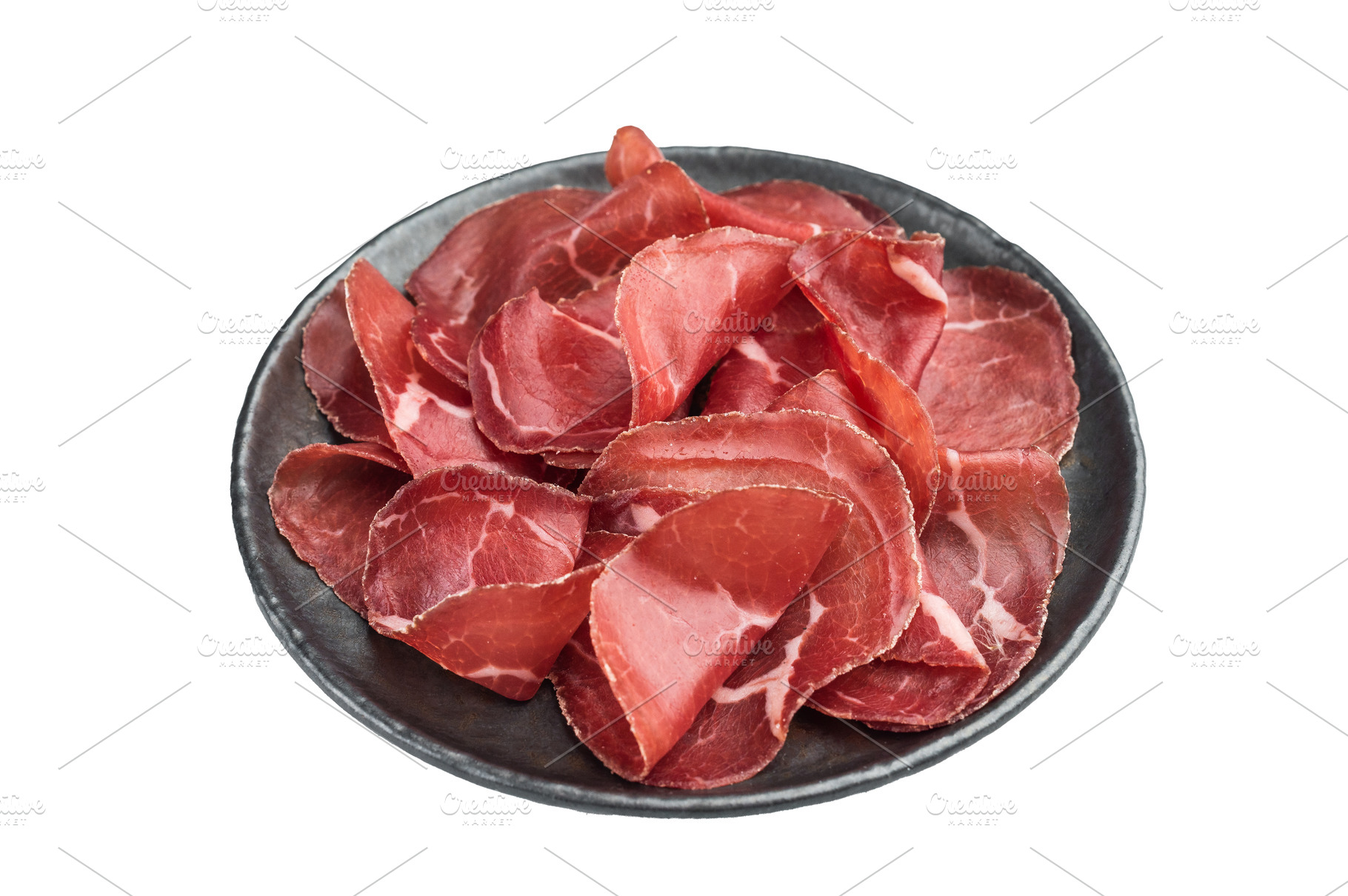 Thin cured beef slices cecina arranged on a dark plate over a cl, a Food & Drink Photo by composter-box@mail.ru