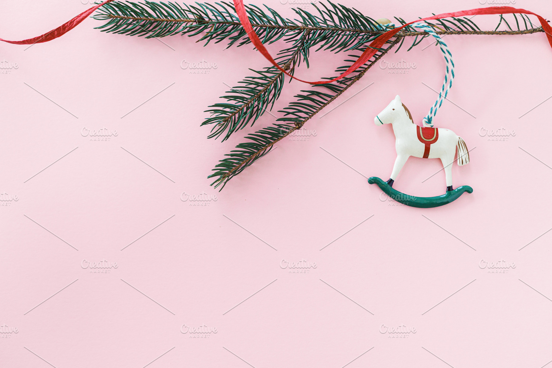 Horse christmas toy on pink flat lay with golden star, bauble an, a Holiday Photo by Sonjachni