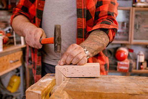 Carpentry workflow hammering nail, a Person Photo by Photo Drive Studio