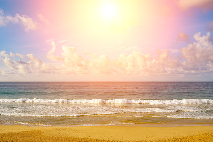Sunset over ocean, sea waves and sand.