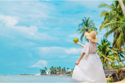 Girl on the beach drinks coconut, a Person Photo by yanadjana