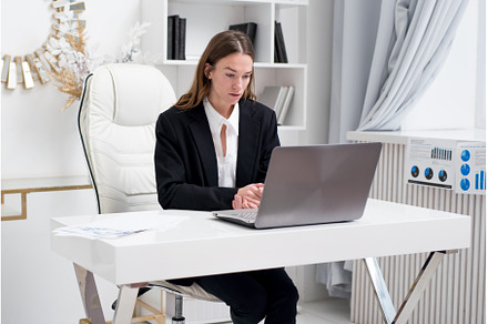 Woman in the office looking at the, a Business Photo by undrey