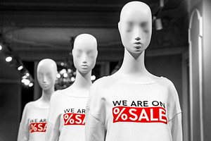 Mannequins with sale signs in a shop, a Business Photo by BOOCYS