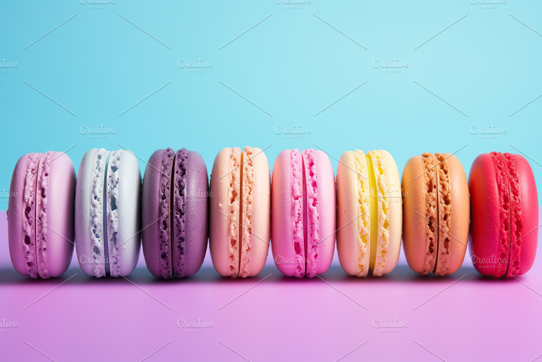 Colorful macarons dessert in a row on blue background, a Food & Drink Photo by AlyaAnd
