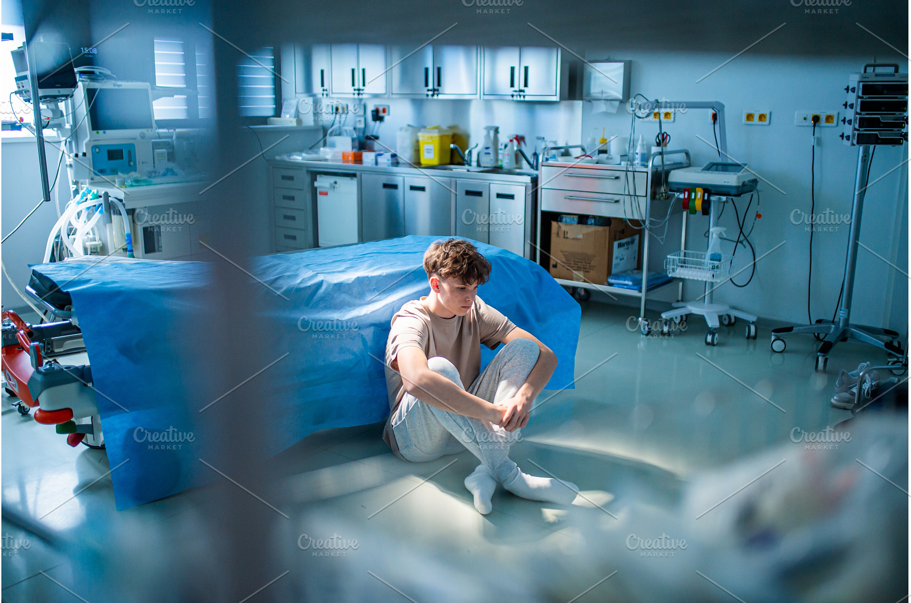 Teenage boy sitting depressed on, a Health & Medical Photo by HalfPoint