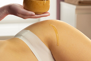 Beautician dripping honey, a Health & Medical Photo by Elena Vagengeim