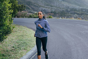 Slim woman runner on road, a Sports & Recreation Photo by Artem Varnitsin