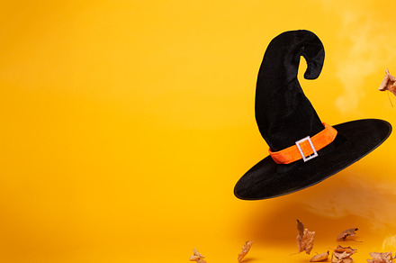 Black witch hat, dry autumn leaves on blank orange background, space for text., a Holiday Photo by Sergey Mironov's store