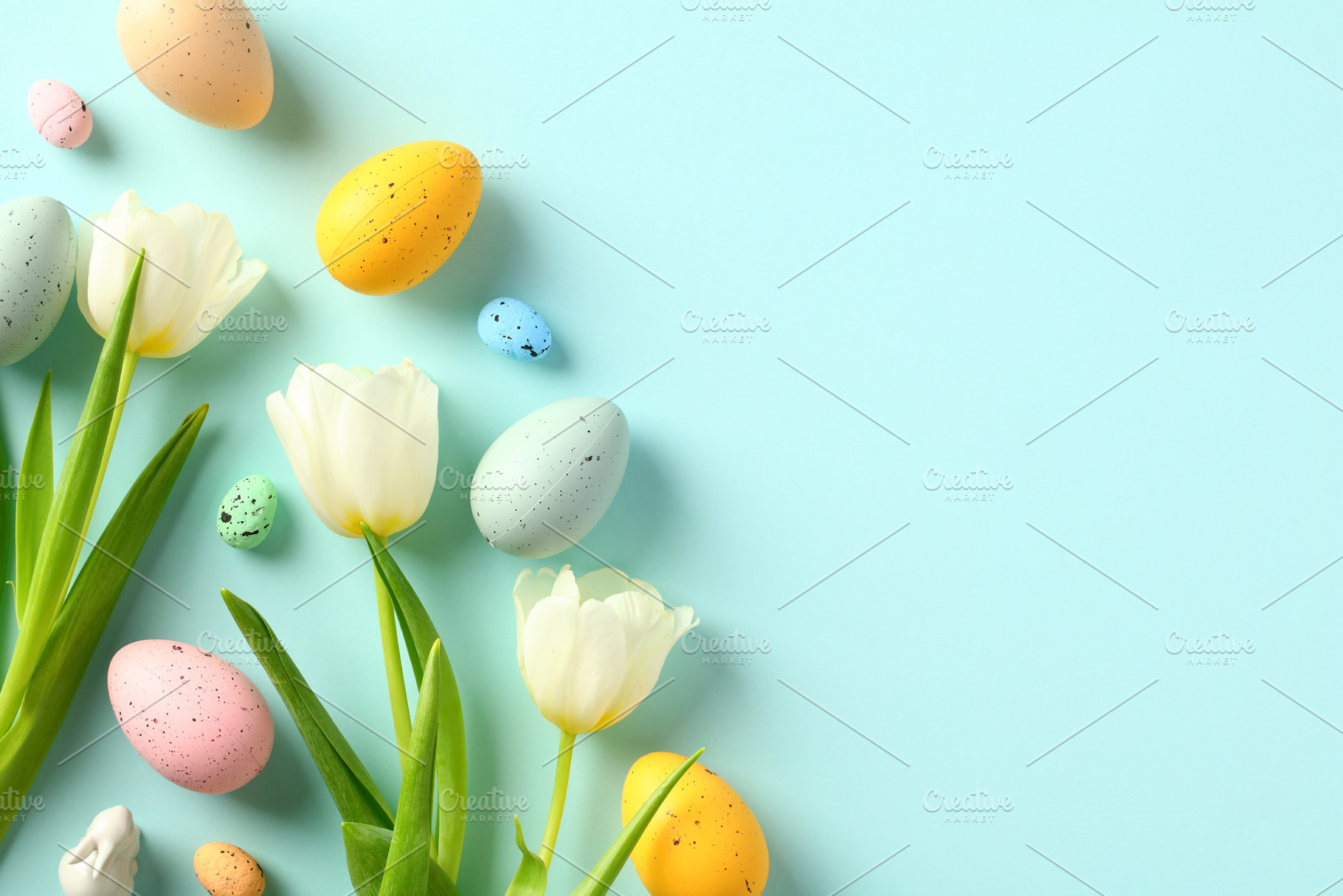 Happy Easter greeting card design. Flat lay tulips and Easter eggs on pastel bl, a Holiday Photo by photoguns