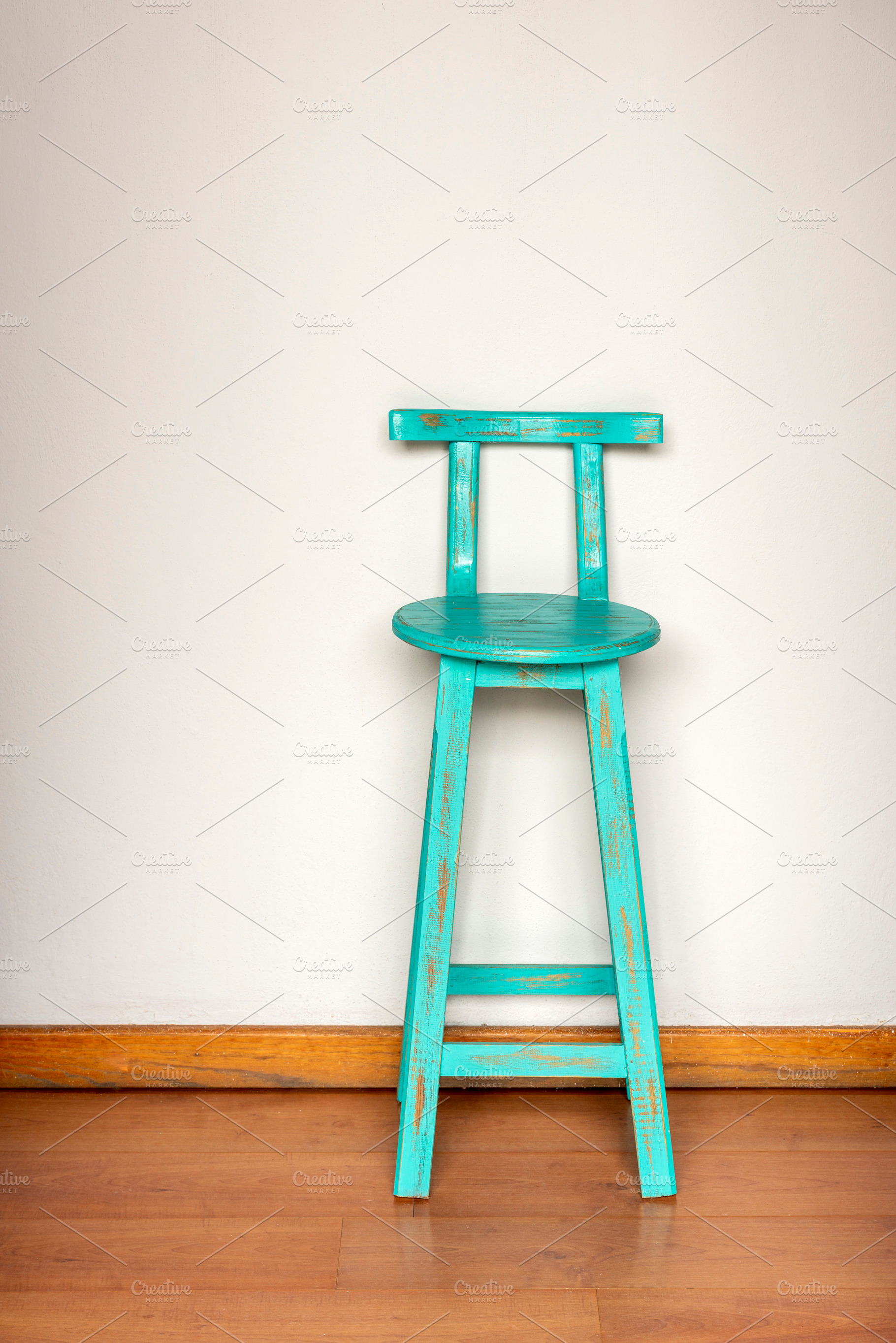 Blue Wooden Stool Against Wall, a Photo by THP Creative