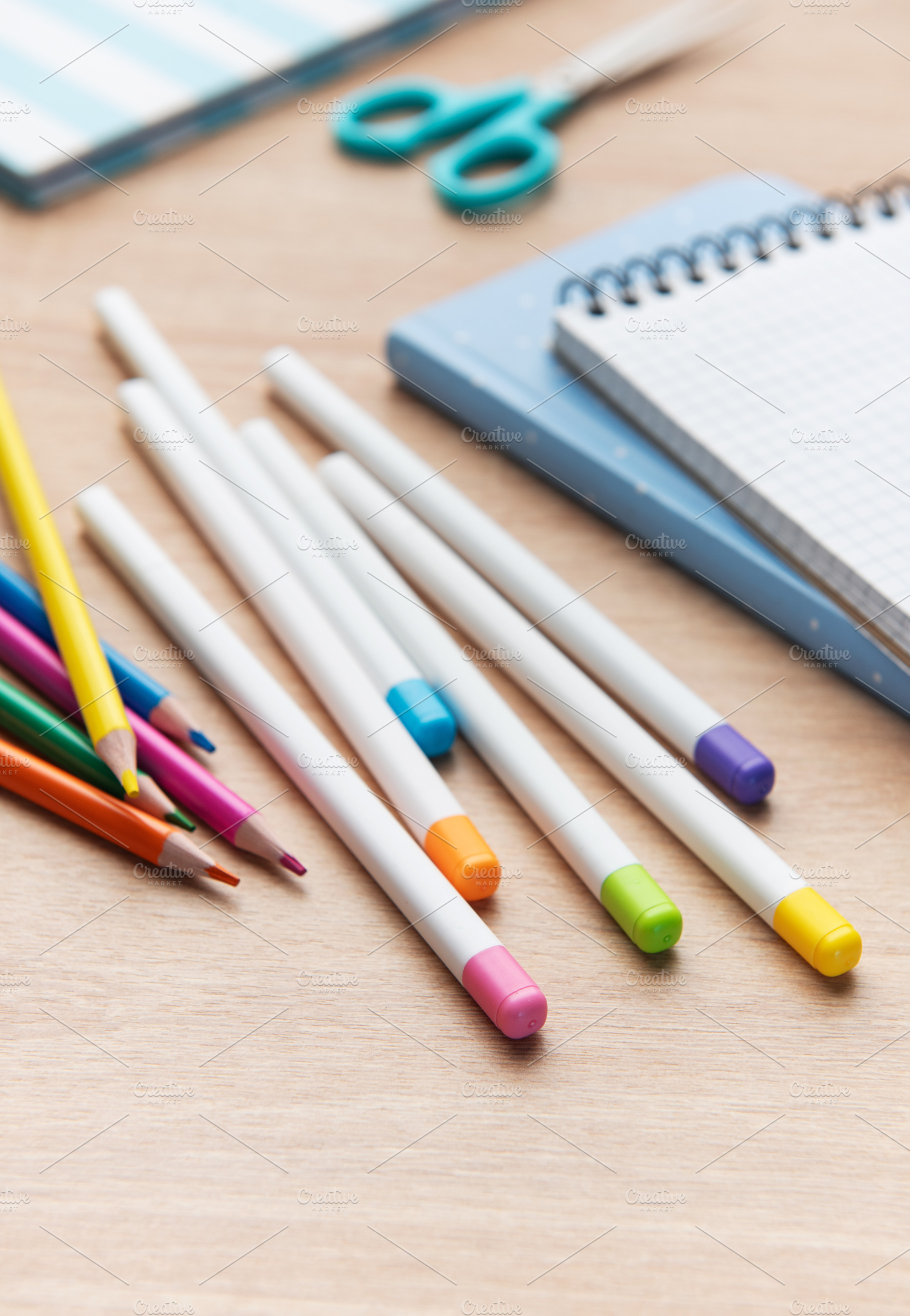 Colorful pencils and school supplies on wooden table, a School & Education Photo by Olena Rudo