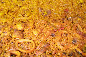 Seafood paella with squid and rice close-up, a Food & Drink Photo by DanFLCreativo