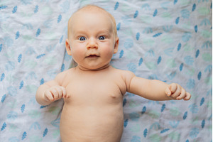 Curious baby lying on a soft blanket, a Person Photo by Elizaveta Galitskaya